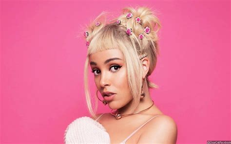 Doja Cat displays the results of her recent breast reduction